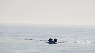 FILE - A group of people thought to be migrants arrive in an inflatable boat at Kingsdown beach after crossing the English Channel, near Dover, Kent, England, 2020.