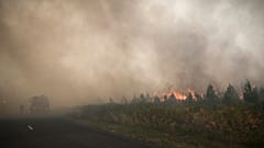 Firefighters take positions at a forest fire near Louchats, 35 kms (22 miles) from Landiras in Gironde, southwestern France, Monday, July 18, 2022. 