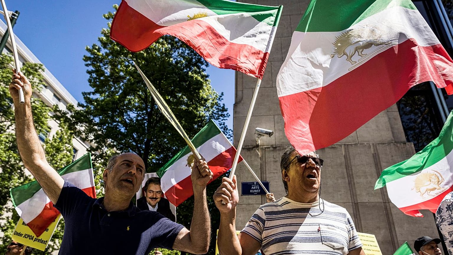 Iranian opposition supporters protest outside the US embassy during a NATO summit in Brussels.