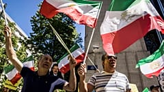 Iranian opposition supporters protest outside the US embassy during a NATO summit in Brussels.