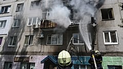 Ukrainian firefighters put out a blaze in a residential apartment, July, 2022. 