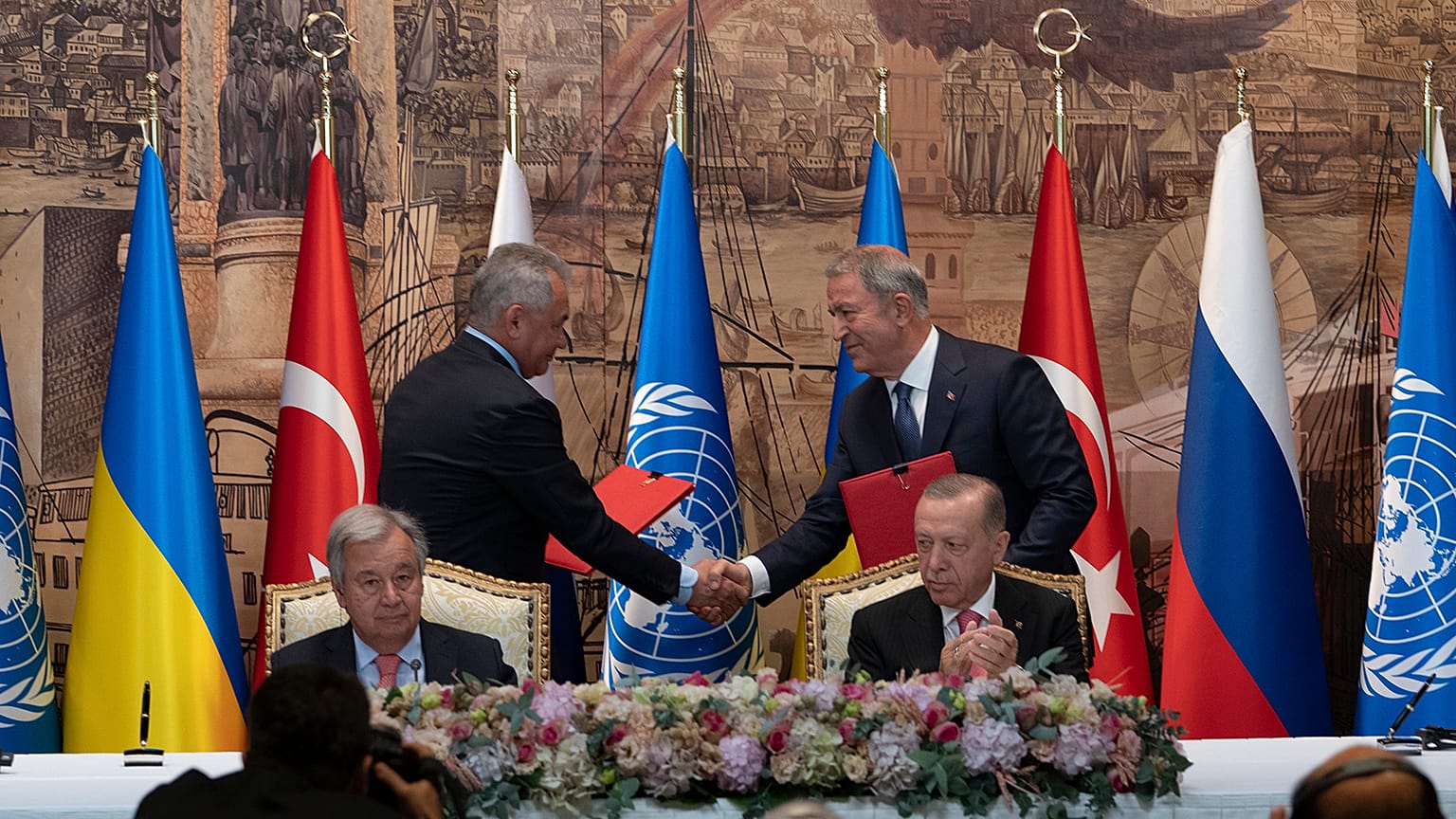 Representatives of Ukraine and Russia delegations shook hands during the signing ceremony in Istanbul
