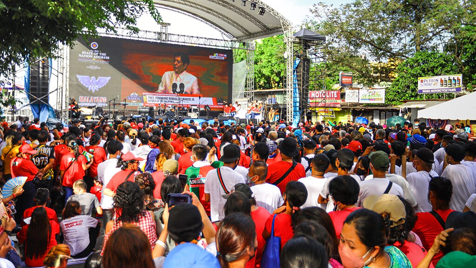 Supporters of new President Ferdinand Marcos Jr. watch the state of nation speech in a big screen