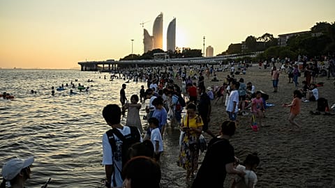 People gather at Baicheng beach in Xiamen.