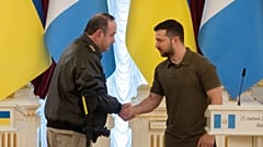 Ukrainian President Volodymyr Zelenskyy and Guatemalan President Alejandro Giammattei shake hands during a news conference after their meeting in Kyiv, 25 July 2022.