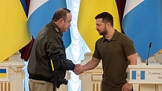 Ukrainian President Volodymyr Zelenskyy and Guatemalan President Alejandro Giammattei shake hands during a news conference after their meeting in Kyiv, 25 July 2022.