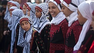 فتيات فلسطينيات يرتدين الفساتين التقليدية في مظاهرة بمناسبة يوم العادات التقليدية الفلسطينية، في مدينة غزة، الثلاثاء 30 يوليو 2019
