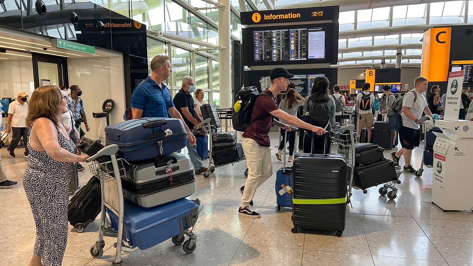 Travellers at Heathrow airport, in London, Wednesday, July 13, 2022. 