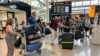 Travellers at Heathrow airport, in London, Wednesday, July 13, 2022.