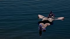 Jury member floating on the Dead Sea, reading the festival catalog, July 25, 2022.