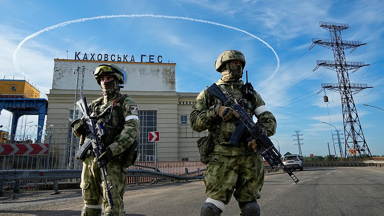 Russian troops guard an entrance of the Kakhovka Hydroelectric Station, a run-of-river power plant on the Dnieper River in Kherson region, 20 May 2022