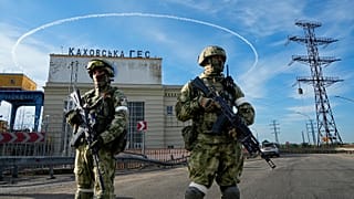 Russian troops guard an entrance of the Kakhovka Hydroelectric Station, a run-of-river power plant on the Dnieper River in Kherson region, 20 May 2022