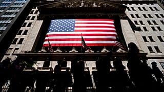 People walk past the New York Stock Exchange on Wednesday, June 29, 2022 in New York.