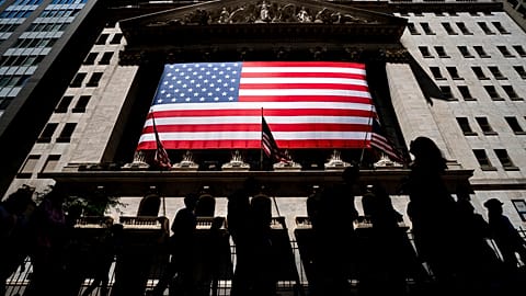 People walk past the New York Stock Exchange on Wednesday, June 29, 2022 in New York.