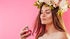 A woman sprays herself with perfume