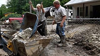 Zwei Männer schaffen in Hindman Schlamm fort