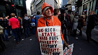 A protester, name not given, demonstrates against rising energy prices outside the headquarters of energy provider Npower in London, Tuesday, 26 Nov., 2013. 