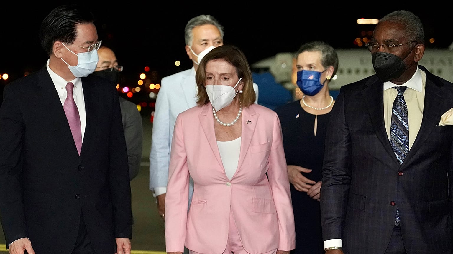 U.S. House Speaker Nancy Pelosi, center, walks with Taiwan's Foreign Minister Joseph Wu, left, as she arrives in Taipei, Taiwan, Tuesday, Aug. 2, 2022.