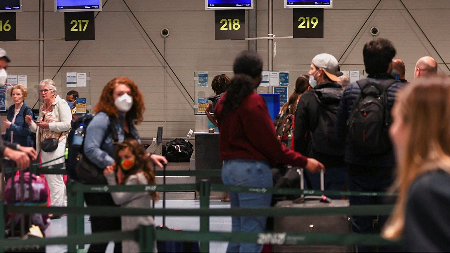 People wait on the Ryanair check-in line at Lisbon Humberto Delgado Airport