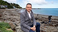 New Zealand Climate Change Minister James Shaw poses for a photo at Owhiro Bay beach in Wellington, New Zealand, Wednesday, Aug. 3, 2022.