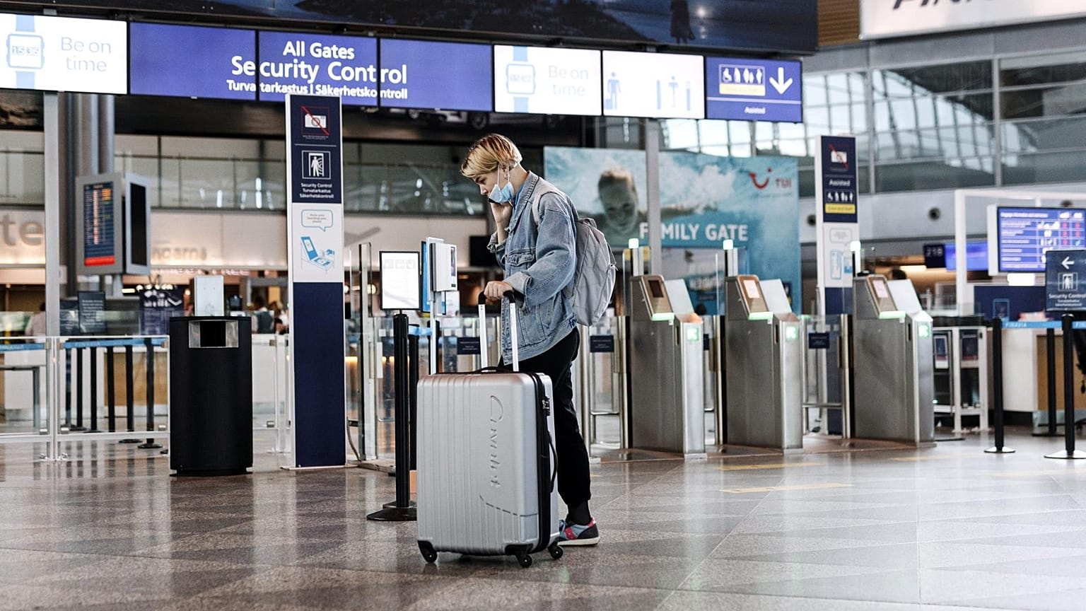 A passenger wearing a face mask walks at the Helsinki-Vantaa airport in Vantaa, Finland.