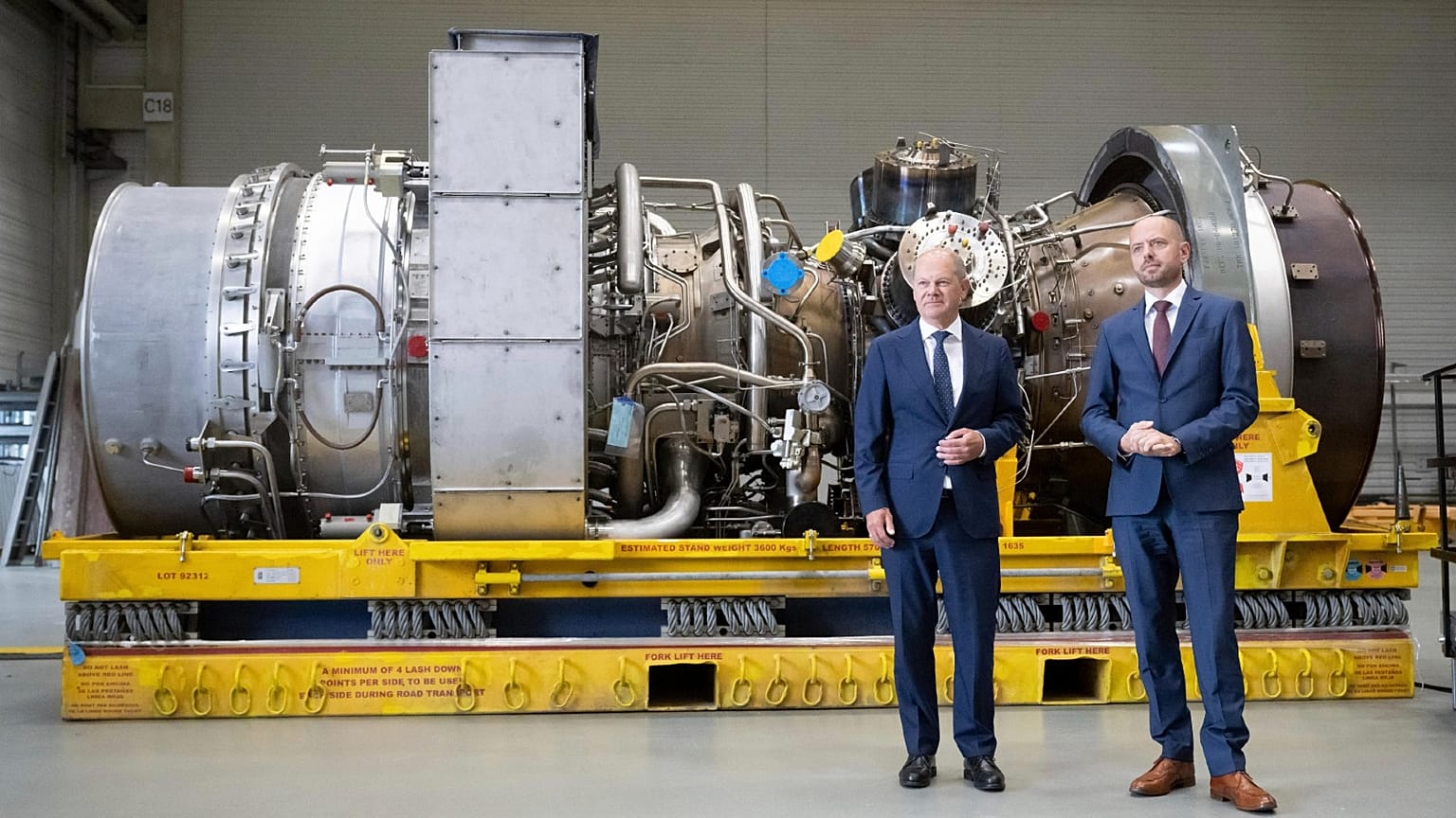 German Chancellor Olaf Scholz, left, and Christian Bruch, CEO of Siemens Energy, with the turbine for the Nordstream 1 pipeline in Muelheim an der Ruhr, Germany, Aug. 3, 2022.