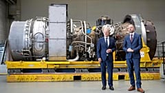German Chancellor Olaf Scholz, left, and Christian Bruch, CEO of Siemens Energy, with the turbine for the Nordstream 1 pipeline in Muelheim an der Ruhr, Germany, Aug. 3, 2022.