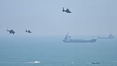Chinese military helicopters fly past Pingtan island, one of mainland China's closest point from Taiwan, in Fujian province on August 4, 2022