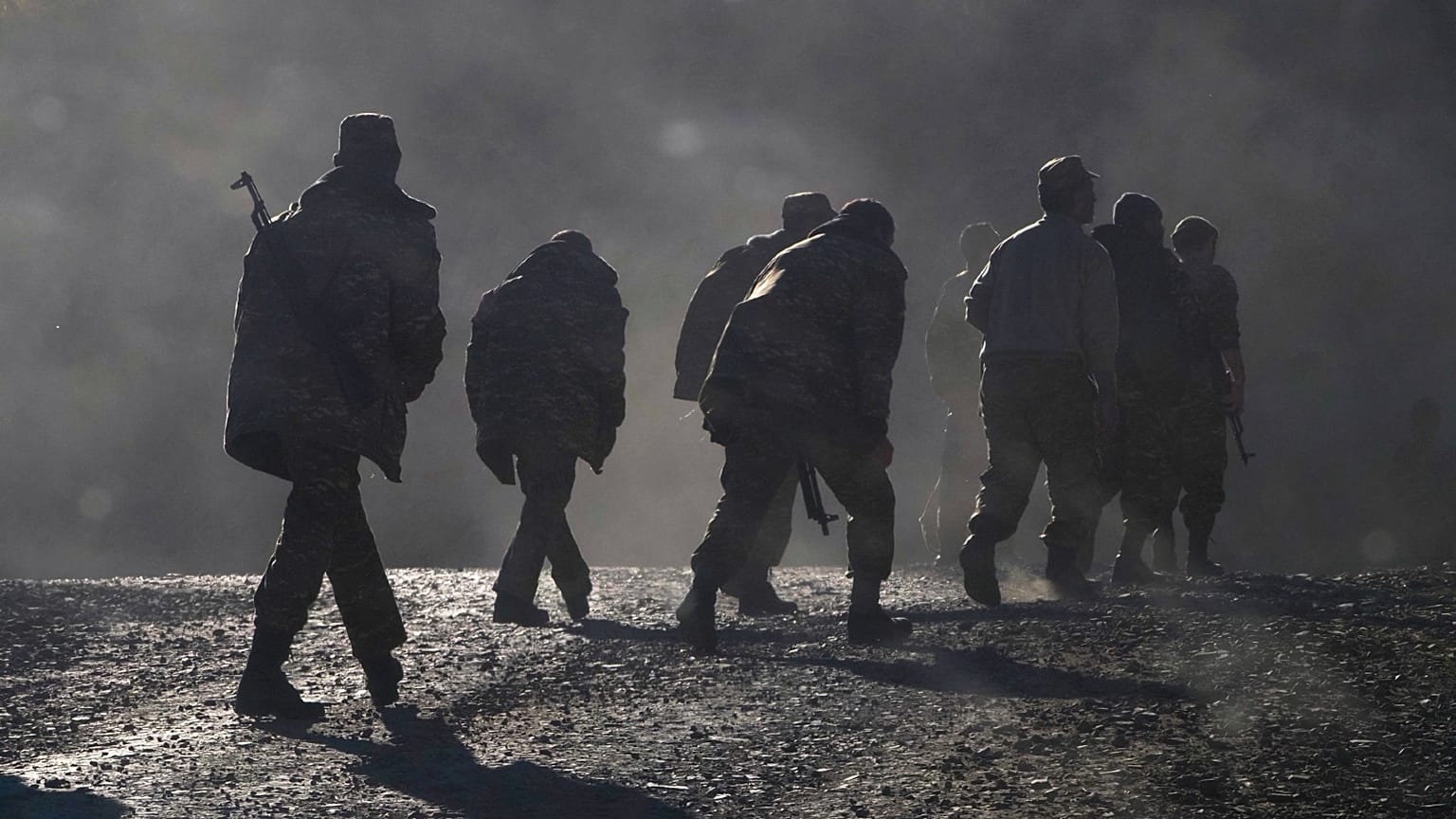 Ethnic Armenian soldiers walk along the road near the border between Nagorno-Karabakh and Armenia, Nov. 8, 2020.