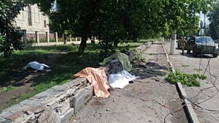 Bodies of people killed by a Russian military strike are pictured near a stop of a public transport in the town of Toretsk
