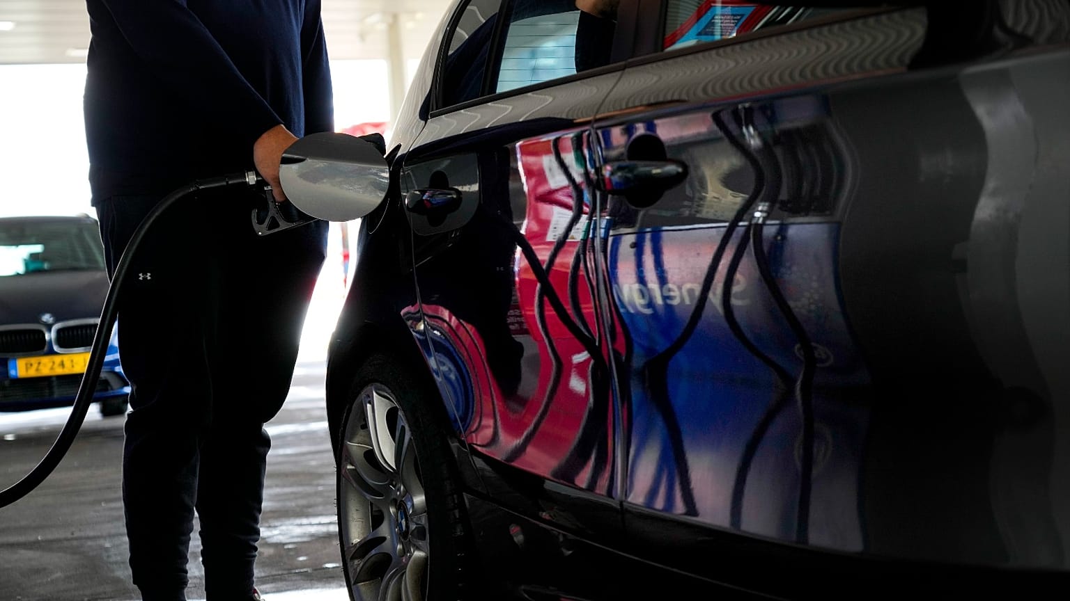 FILE - A man fills his car with gasoline at a petrol station in Amsterdam, Netherlands, on April 1, 2022. 