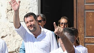 Matteo Salvini and Leader of The League party, leaves the town hall building during his visit in the Sicilian Island of Lampedusa, Italy (AP Photo/David Lohmueller))