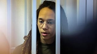 WNBA star and two-time Olympic gold medalist Brittney Griner stands behind bars in a courtroom for a hearing, in Khimki just outside Moscow, Russia, Tuesday, Aug. 2, 2022.