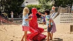 Children react to the work of James Colomina, installed in Central Park in New York, on August 3, 2022