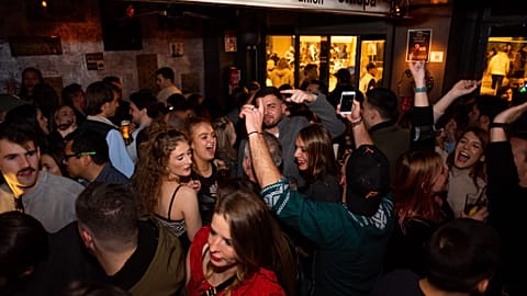 Young people are seen dancing and drinking inside a bar in Barcelona in January 2022