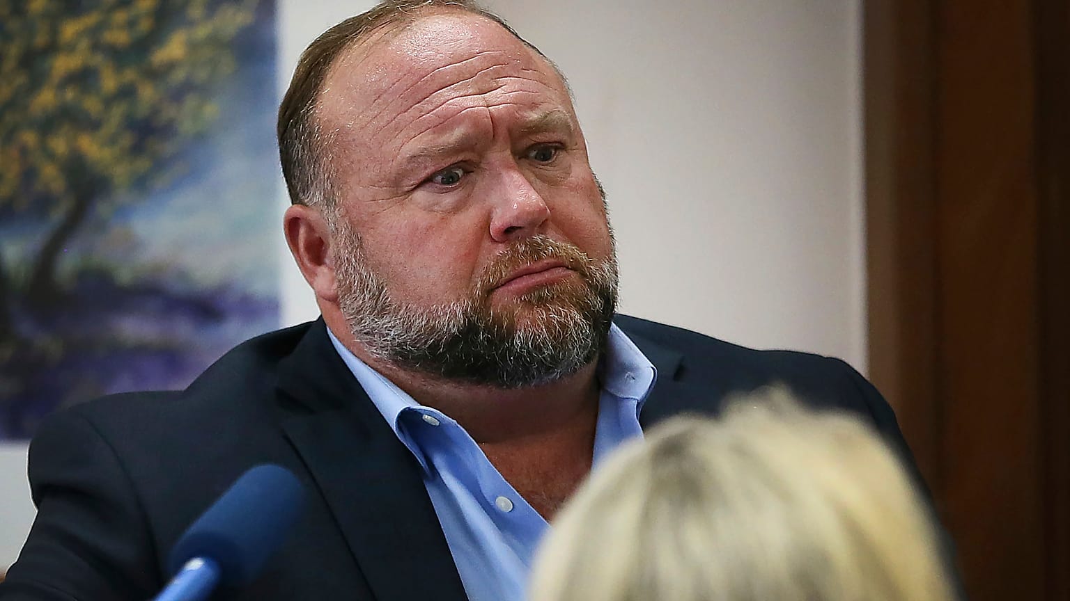 In this Aug 3, 2022 file photo, conspiracy theorist Alex Jones attempts to answer questions about his emails during trial at the Travis County Courthouse in Austin.