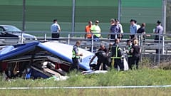 Rescuers remove a body from the wreckage of a bus at the crash scene in Podvorec, near Zagreb, Croatia, Saturday, Aug. 6, 2022. 