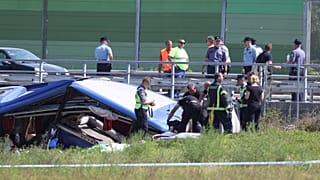 Rescuers remove a body from the wreckage of a bus at the crash scene in Podvorec, near Zagreb, Croatia, Saturday, Aug. 6, 2022. 