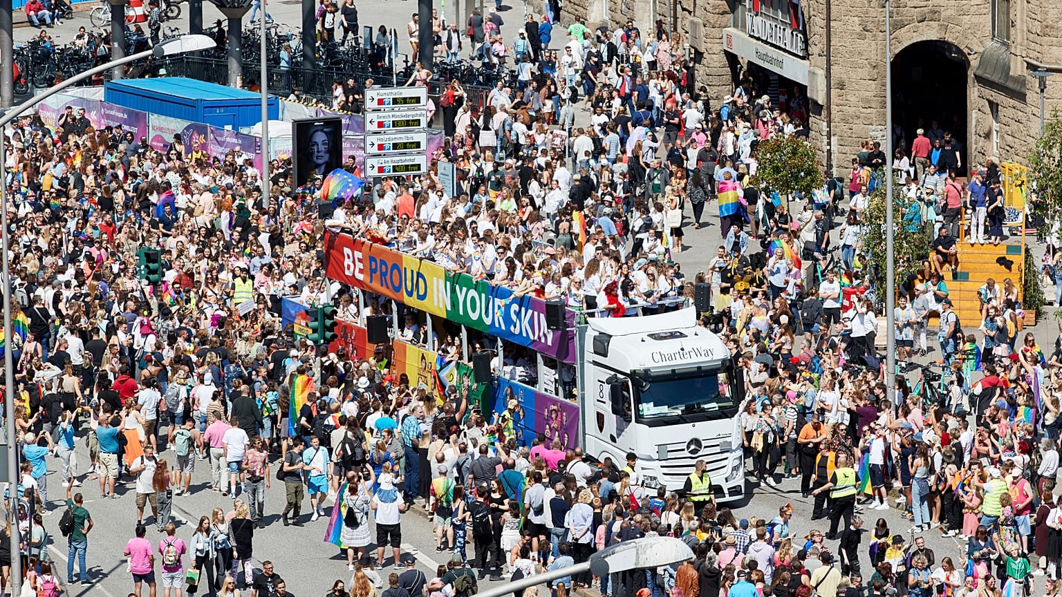 People participants walk along Hamburg Central Station during the Christopher Street Day (CSD) parade in Hamburg, Germany, Saturday, Aug. 6, 2022.