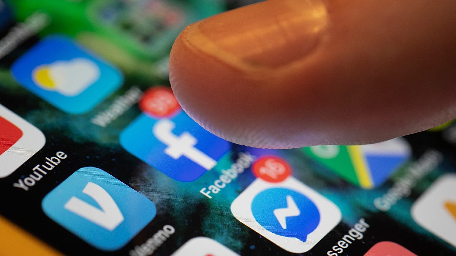 An iPhone displays the apps for Facebook and Messenger.