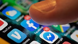 An iPhone displays the apps for Facebook and Messenger.
