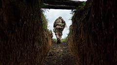 Sergeant Major Artur Shevtsov with the Dnipro-1 regiment exits a bunker at the unit's position near Sloviansk 5 August, 2022