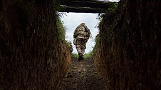 Sergeant Major Artur Shevtsov with the Dnipro-1 regiment exits a bunker at the unit's position near Sloviansk 5 August, 2022