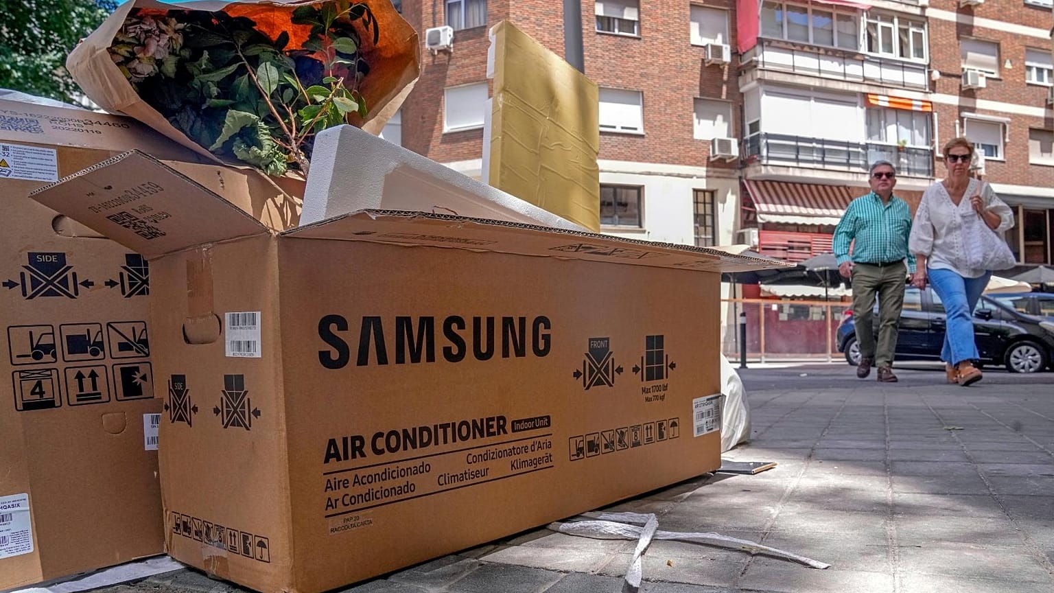 Empty air conditioner unit boxes lie on a street corner in Madrid, Spain, Sunday, 19 June, 2022. 