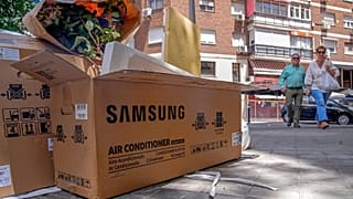Empty air conditioner unit boxes lie on a street corner in Madrid, Spain, Sunday, 19 June, 2022. 