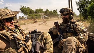 Ukrainian servicemen of "Fireflies" reconnaissance team ride to the position in the trunk of pickup at the frontline in Mykolaiv region, Ukraine, on Monday, 8 August, 2022. 