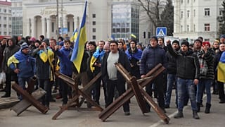 People shout toward Russian army soldiers during a rally against the Russian occupation in Svobody (Freedom) Square in Kherson, Ukraine, Monday, March 7, 2022