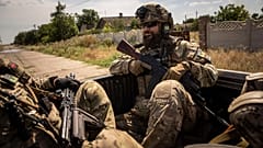 Ukrainian servicemen of "Fireflies" reconnaissance team ride to the position in the trunk of pickup at the frontline in Mykolaiv region, Ukraine, on Monday, Aug. 8, 2022. 