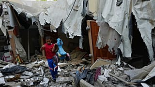 الطفل محمد عرادة ينتشل دراجته من تحت أنقاض منزل عائلته بعد أن دمرتها غارة جوية إسرائيلية في مخيم رفح للاجئين جنوب قطاع غزة، الإثنين 8 أغسطس 2022.