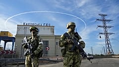Russian troops guard an entrance of the Kakhovka Hydroelectric Station, a run-of-the-river power plant on the Dnieper River in Kherson region, southern Ukraine, May 20, 2022.